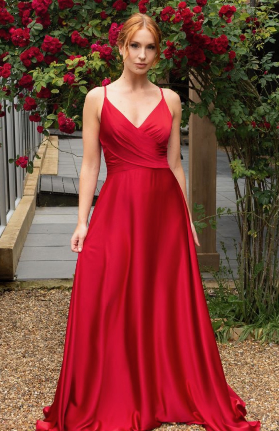 A bridesmaid in a red V-neck satin gown