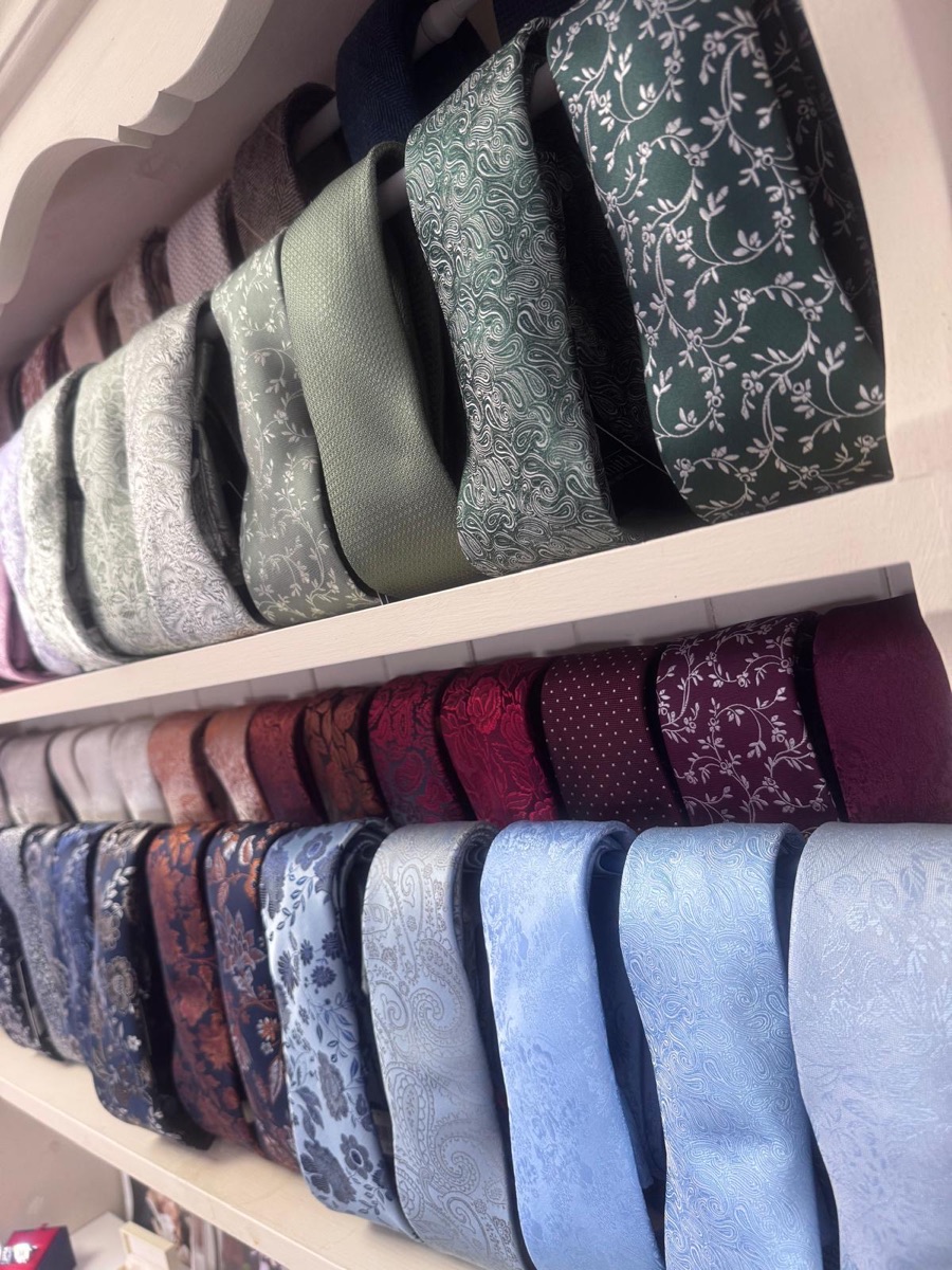 A wall display of patterned wedding ties in many colours