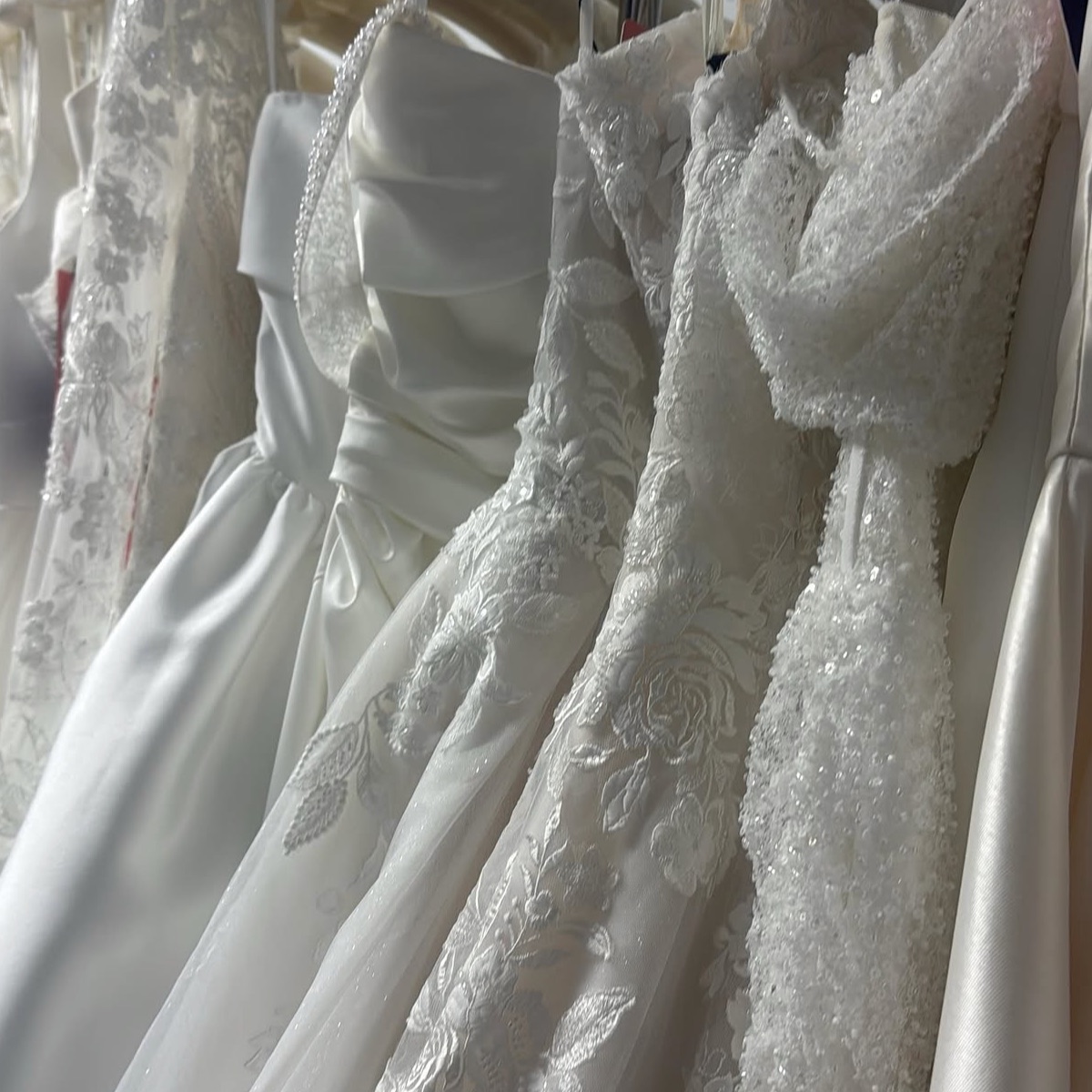 Rails of designer wedding gowns in the boutique